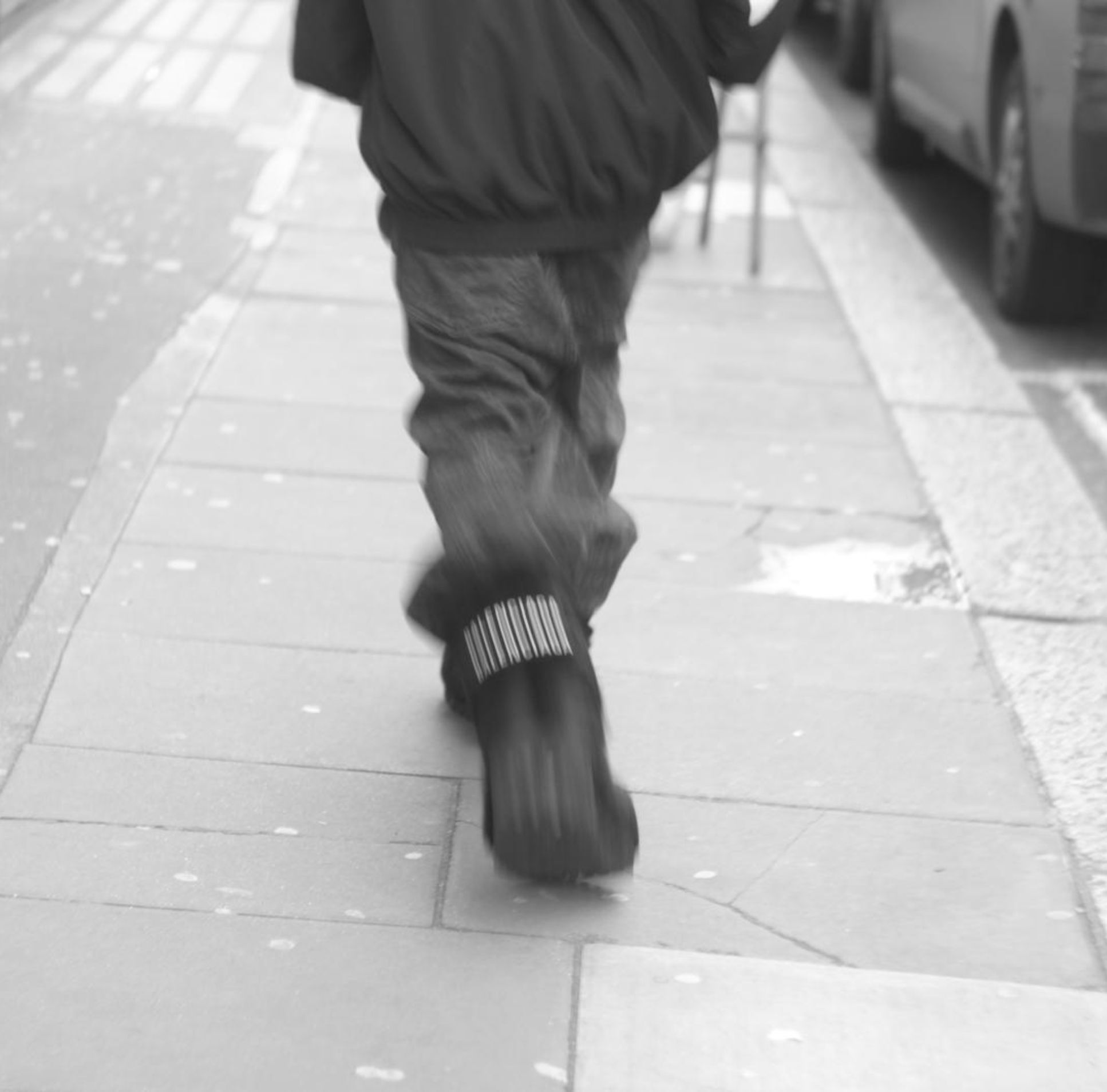 Hat falling in guy's legs in black and white